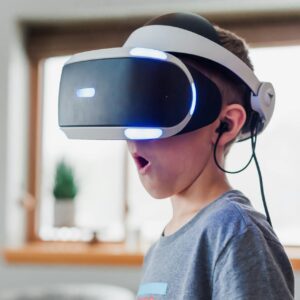 Person immersed in a virtual reality experience with a headset indoors.